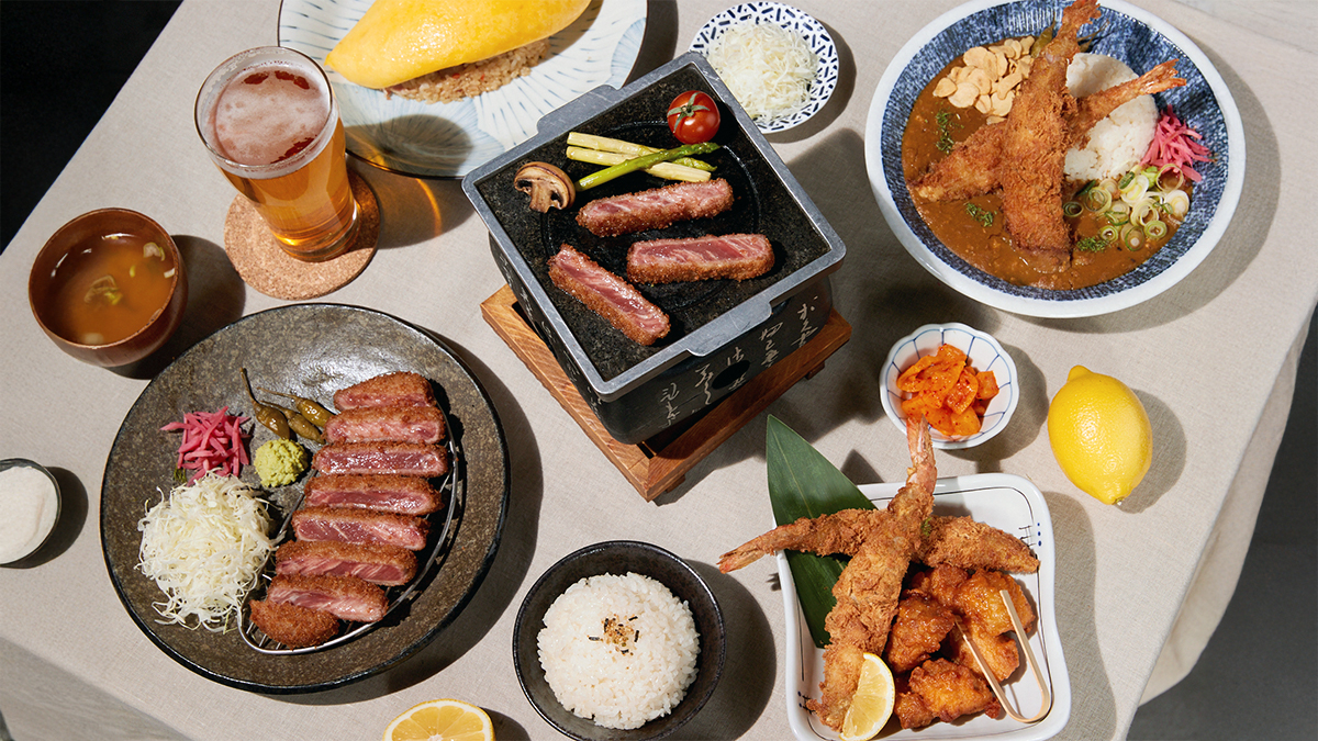 Furato’s signature Japanese-Korean fusion dishes including gyukatsu beef cutlet, half-cooked omurice, steak donburi, and Yamagata curry with fried shrimp, served with rice, soup, and side dishes on a dining table.